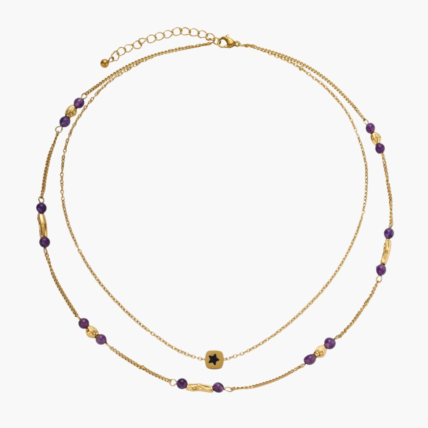 Two layered gold-tone necklaces with purple stone beads and star pendant against cream background.