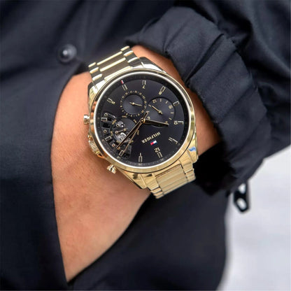Tommy Hilfiger Baker Herrenuhr 1710447 | Goldene Multifunktion | Skelett-Optik & Schwarzes Zifferblatt