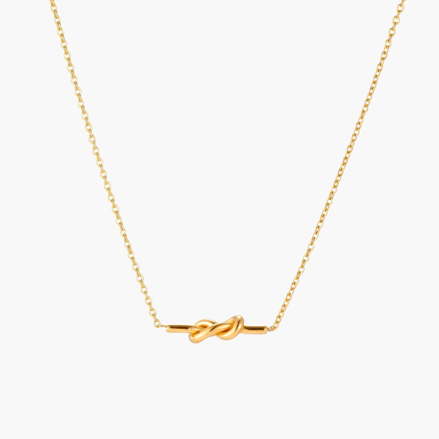 Dainty 18K gold plated necklace with infinity knot pendant on delicate chain against white background